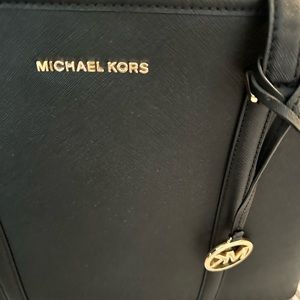 A big Michael Kors bag in black in the very good shape